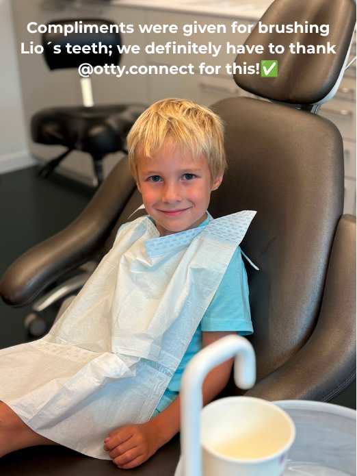 Smiling boy in the dentist chair after compliments about his brushing